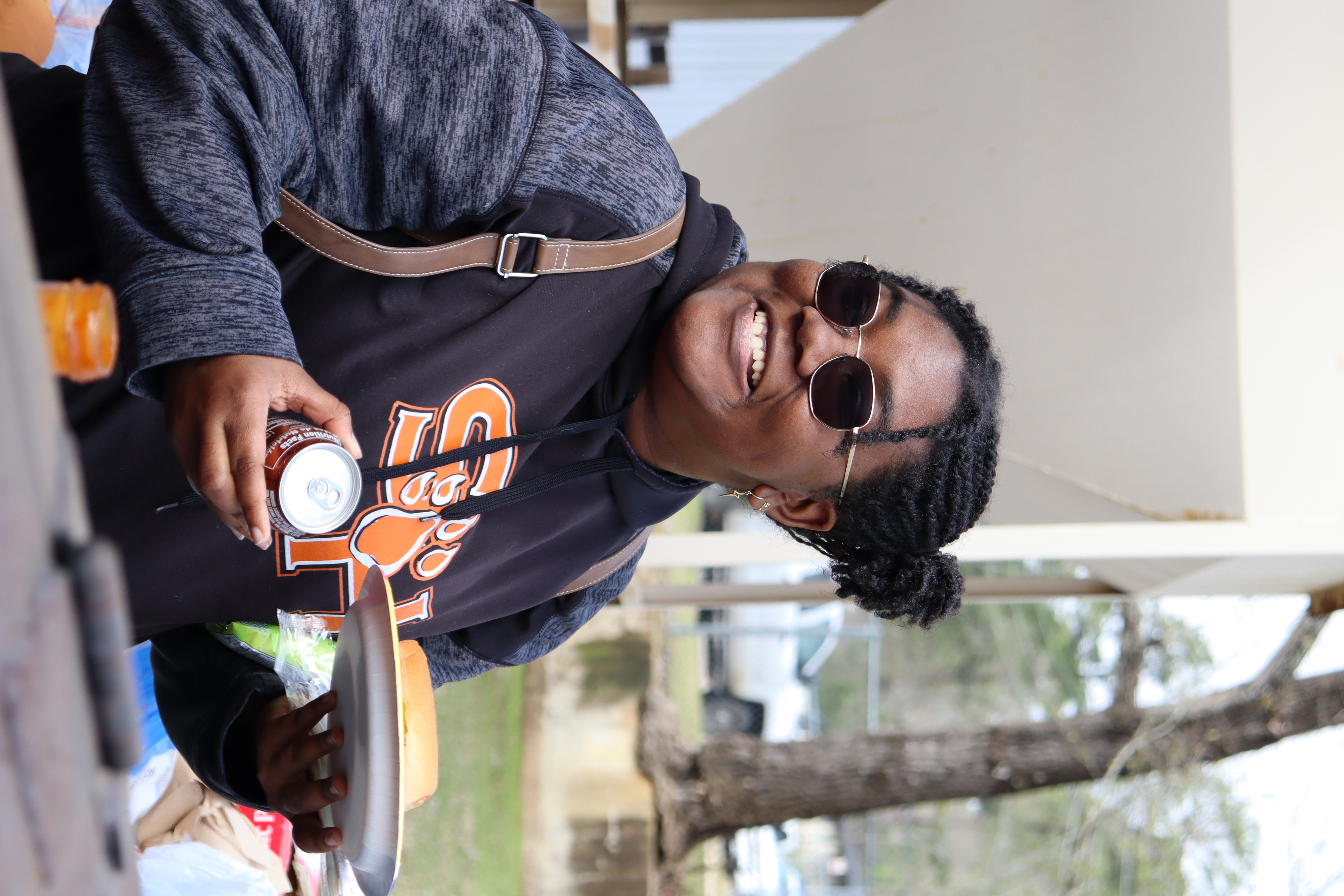 student enjoys bbq sandwich