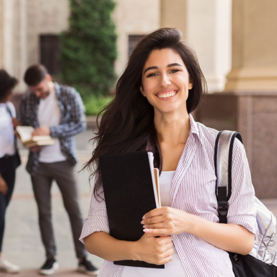 student with backpack and notebook